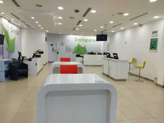 A minimalistic open-plA minimalistic interior view of Safaricom retail centres designed by Arcs Africa Architects in Moi Avenue