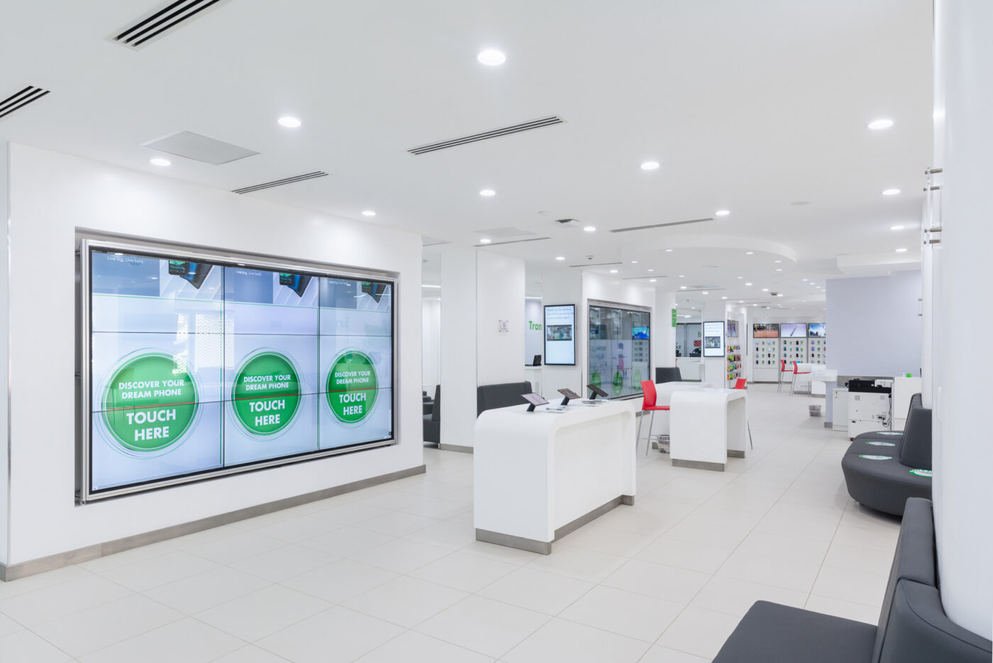 A minimalistic interior view of Safaricom retail centres designed by Arcs Africa Architects in Moi Avenue showing service desks