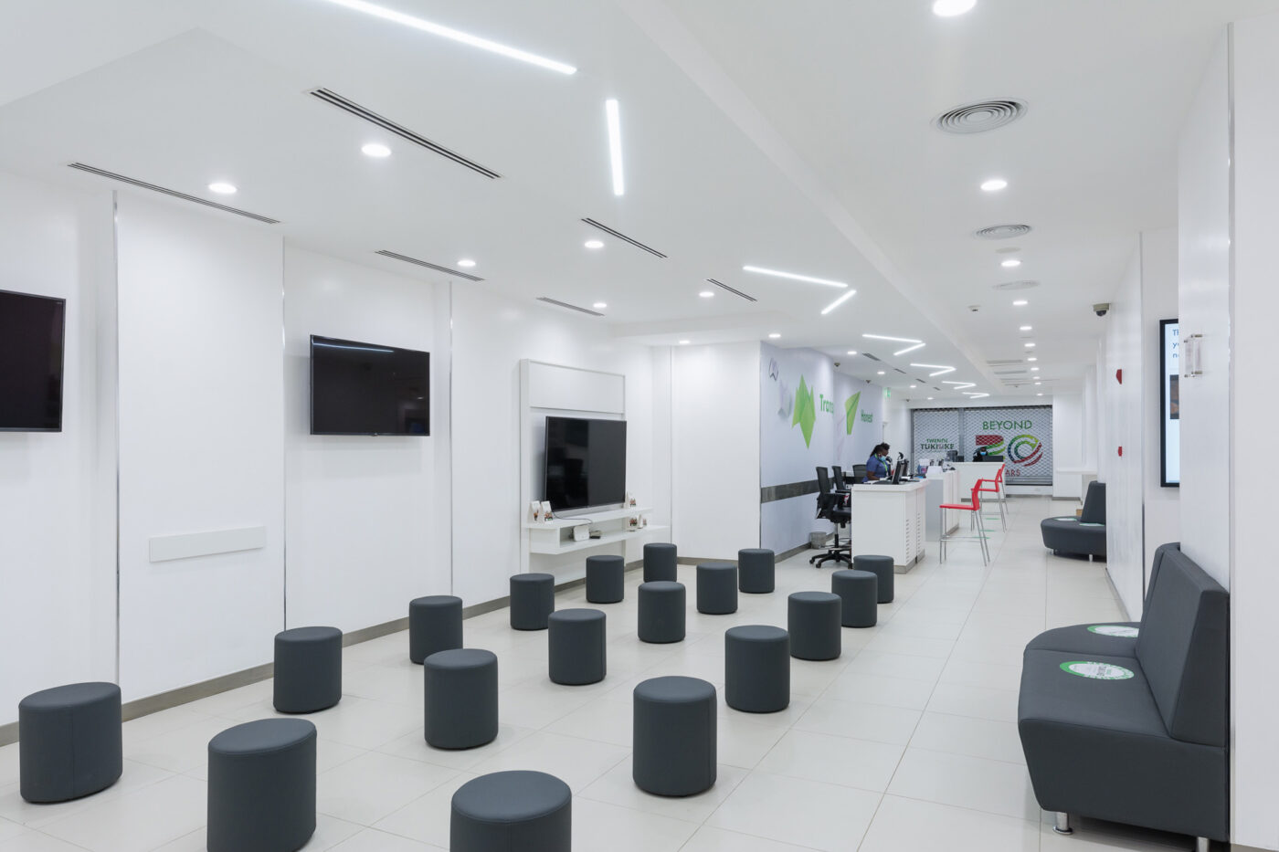Interior of a Safaricom retail centre designed by Arcs Africa showing rounded seats distributed across the space
