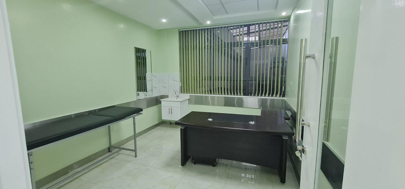 Interior view of Karen Hospital Doctor's suite showing a desk and examination table